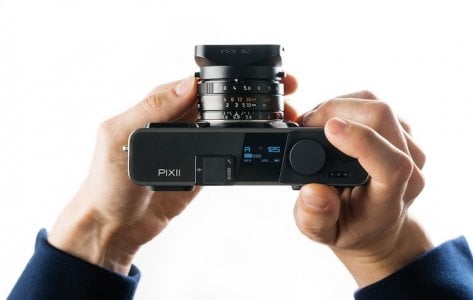 Pixii Max in Matte Black top view held in hands, showing ergonomic form factor and well placed...jpg Pixii Max in Matte Black top view held in hands, showing ergonomic form factor and well placed...jpg